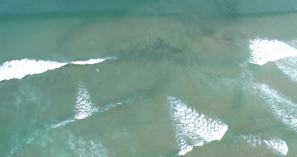 Surfers catching waves in ocean