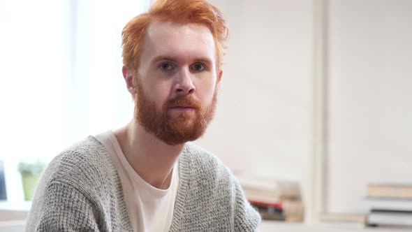 Portrait of Serious Man with Red Hairs