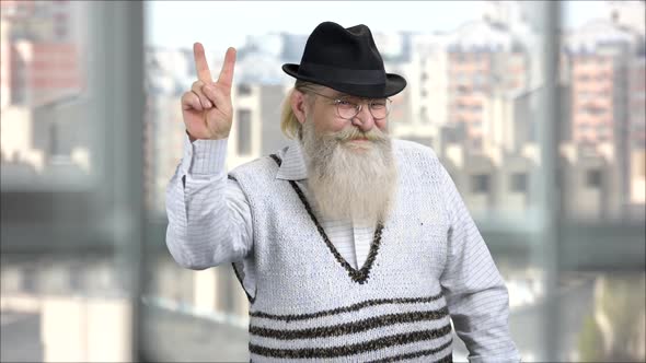 Longbearded Senior Man Showing Peace and Victory Gesture