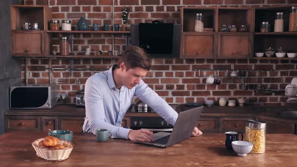 Caucasian Male Reading News on PC Indoors