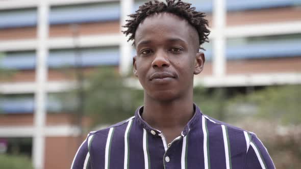 Portrait of Serious Black African Man in the City and Looking to Camera