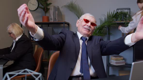 Mature Businessman Dancing Celebrating Sudden Victory Wearing Sunglasses Waiting for Vacation