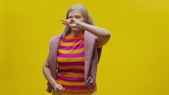 Elderly Woman In Sportswear On Yellow Background