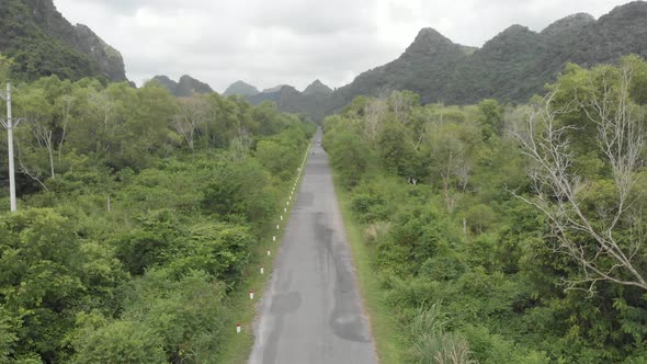 Aerial: people riding scooter inland Cat Ba island, travel destination in Vietnam