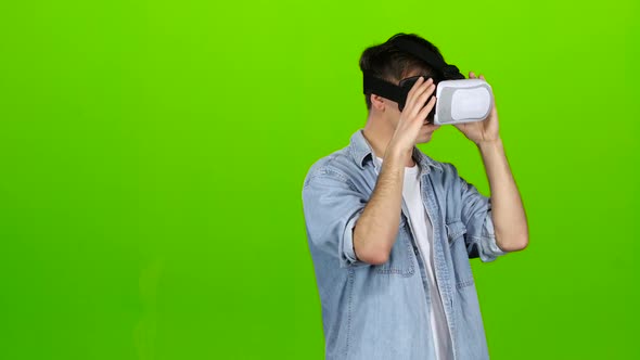 Guy in the Virtual Glasses Is Watching an Interesting Movie. Green Screen