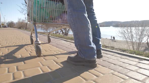 Homeless Man's Legs Walking with Cart