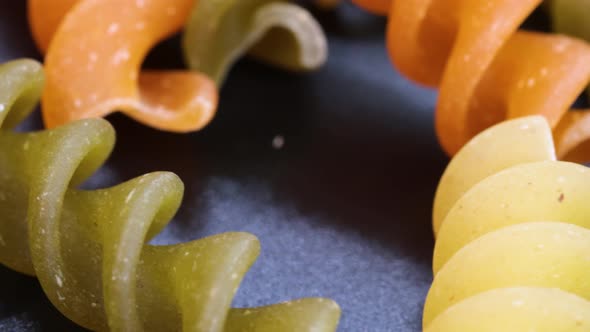 Very close shot of fusilli, italian macaroni, macro shot in 4k. Rotating motion, view from above. Cl