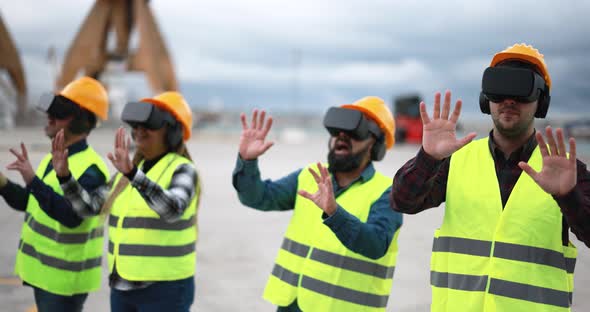 Multiracial workers using virtual reality headsets at industrial terminal Port