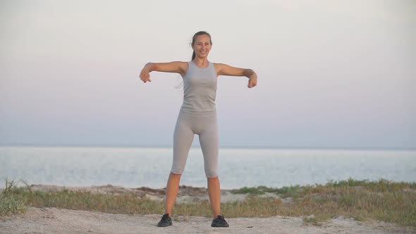 Girl Exercises Near the Sea