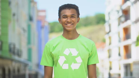 Cheery Young Eco-Volunteer in Recycling Sign T-Short Smiling on Cam, Save Nature