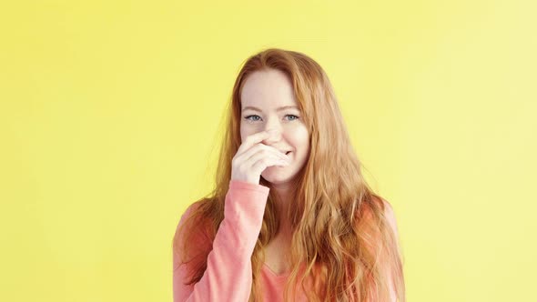 portrait of beautiful woman playfully looks at camera and laughs