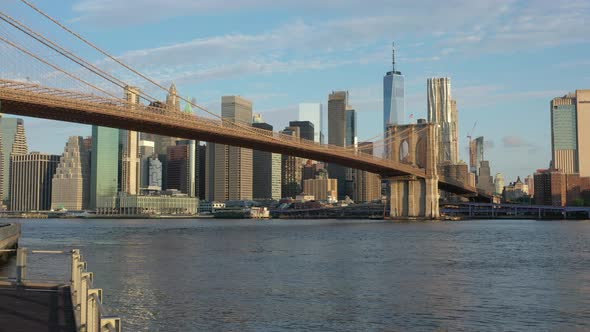 An aerial view from the Brooklyn side of the East River on a beautiful day. The camera dolly out, bo