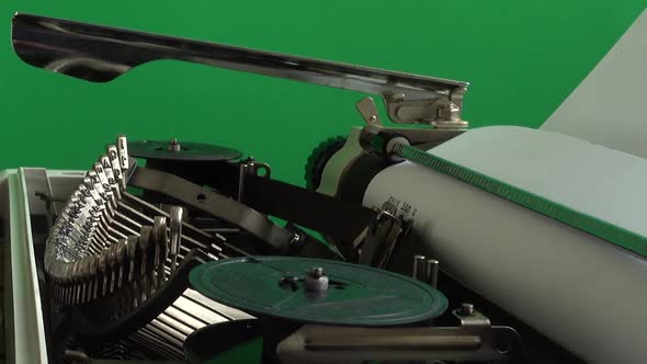 The typing on a retro typewriter on a green background. Chromakey.