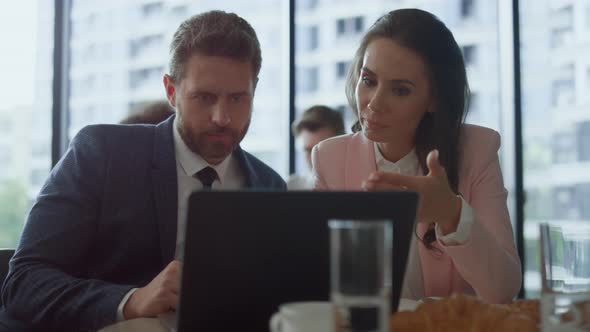 Successful Entrepreneur Couple Talking Video Chat Using Laptop Computer in Cafe