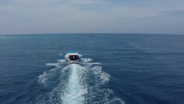 Tourist White and Blue Motorboat Catamaran Sails on Ocean