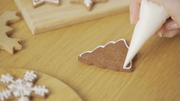 Close-up of a woman decorating a homemade gingerbread Christmas tree