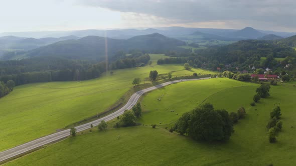 Cars driving on new countryside highway leading to czech village.