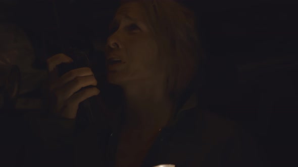 Woman with Flashlight in Dark Shelter Talking on Walkie-talkie