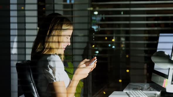 Businesswoman text messaging on mobile phone