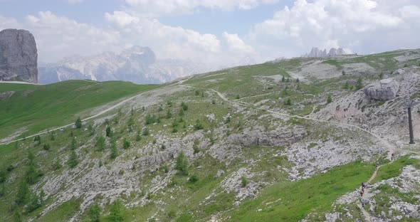 Aerial drone view of a group of people hiking in the mountains.