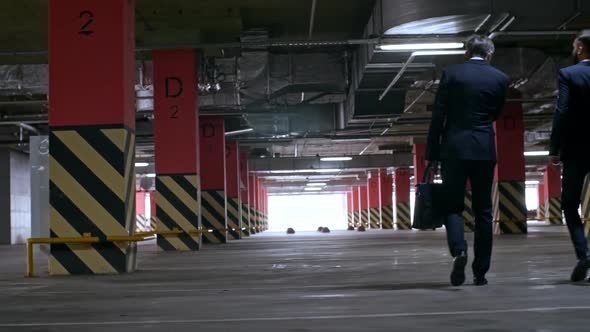 Businessmen in Suit Walking in Underground Garage