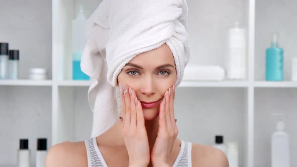 Portrait of Morning Woman Applying Cosmetic Cream on Face