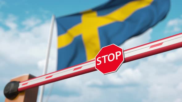 Opening Boom Barrier with Stop Sign at the Swedish Flag