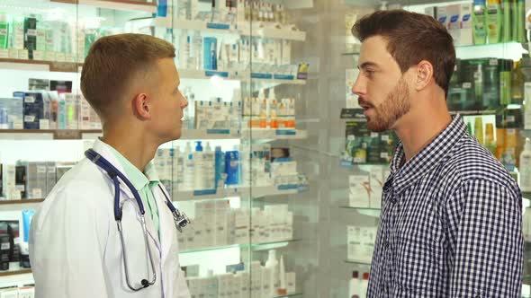 Doctor Talking To Patient in Drugstore
