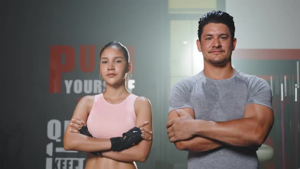 Portrait of Active athlete sport man and woman stand with confidence, crossing arms in fitness gym.