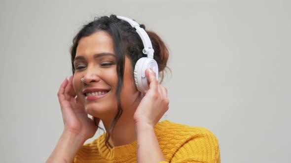 Happy Woman in Headphones Listening To Music