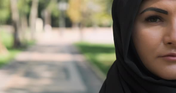 Half Face Portrait of Muslim Woman Looking at Camera Closeup