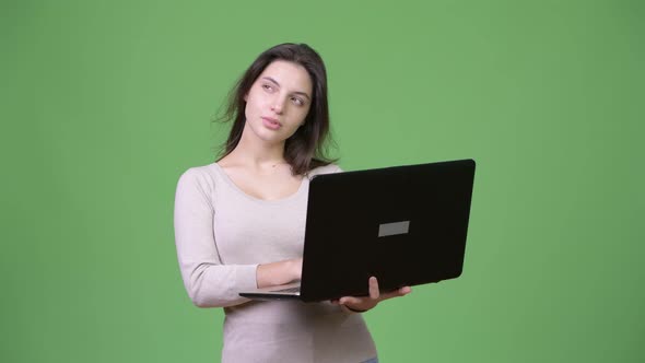 Young Beautiful Woman Thinking While Using Laptop