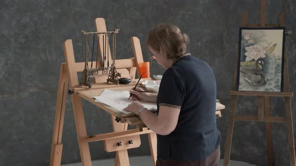 Authentic Senior Woman Artist Painting at Easel