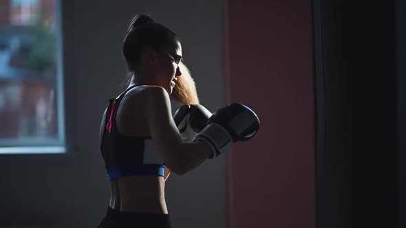 Slow Motion of Kickboxer Girl Is Preparing for Competitions in the Boxing Hall, Practicing the