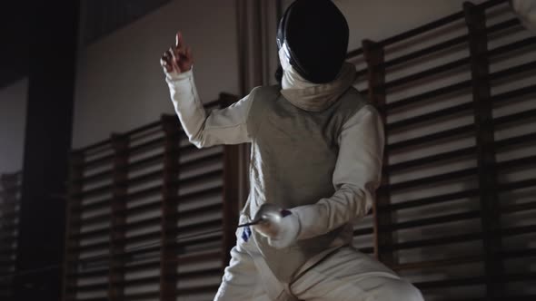 Man In Fencing Mask Duelling Opponent Then Running To Attack