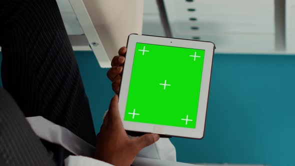 Vertical Video Specialist Holding Digital Tablet with Horizontal Greenscreen