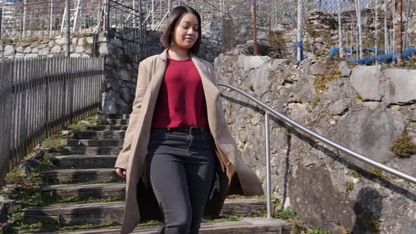 Pan shot of confident young business woman enjoying a view in the Swiss nature