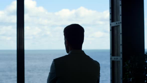 Silhouette Businessman Watching Sea View Big Window