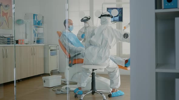 Orthodontists and Patient Wearing Ppe Suits in Oral Cabinet