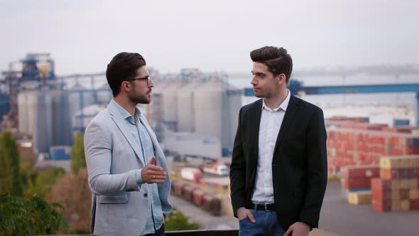 Two Business Partners Discussing the Meeting Outdoor on Background of the Seaport Slow Motion