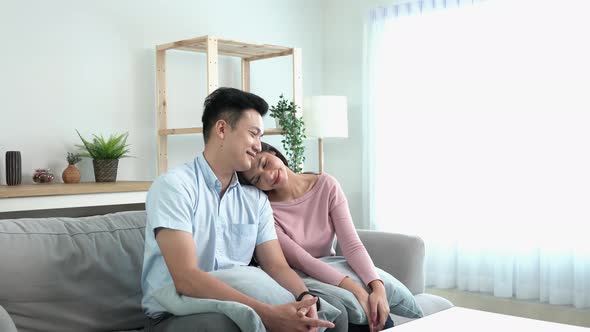 CouplesMan comforting his gril friend mourning friend embracing her in a living room, Wife hugging