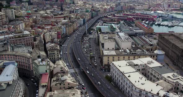 Highway Road through Crowded Urban City of Genova, Italy - Aerial Establishing View
