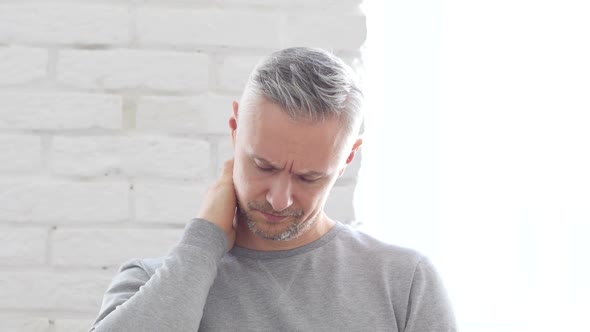 Tired Middle Aged Man at Work Sitting in Office