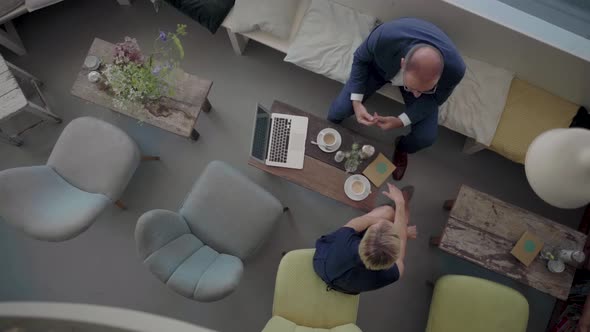 Businessman and woman having a meeting in a coffee shop