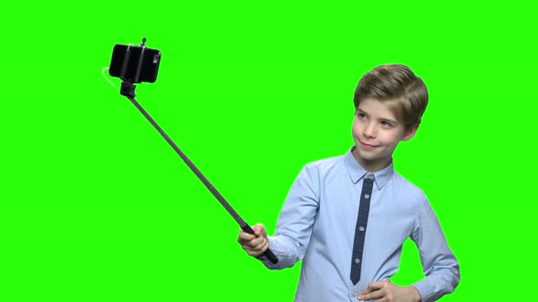 Boy with Selfie Stick Showing Fig on Camera