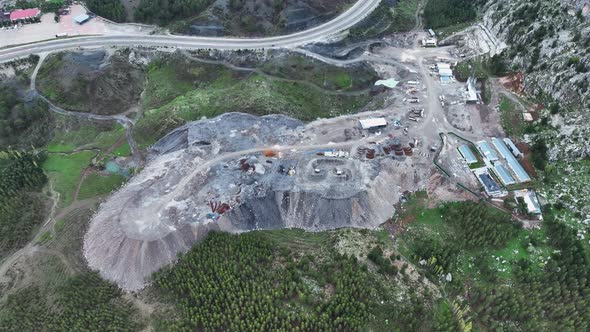 Heavy machinery drills tunnel through the mountain aerial view 4 K