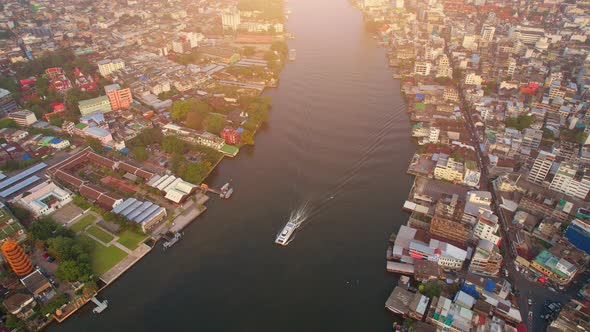 4K UHD : Drones fly over passenger boats moving on the Chao Phraya River