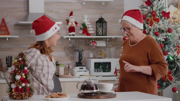 Happy Family Wearing Santa Hat Surprising Each Other with Wrapper Xmas Present Gift