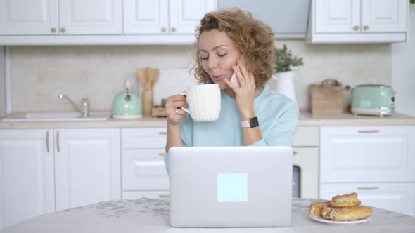 Successful Female Freelancer Working On Laptop Computer And Calling On Phone