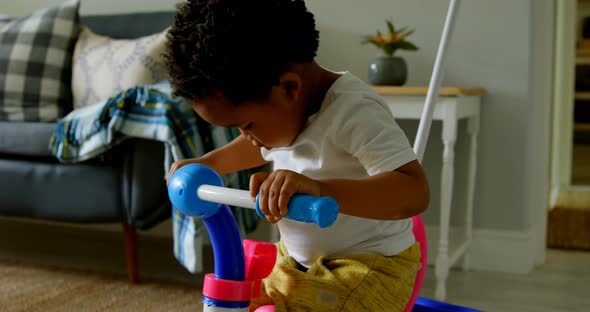 Side view of cute little black boy playing in a comfortable home 4k